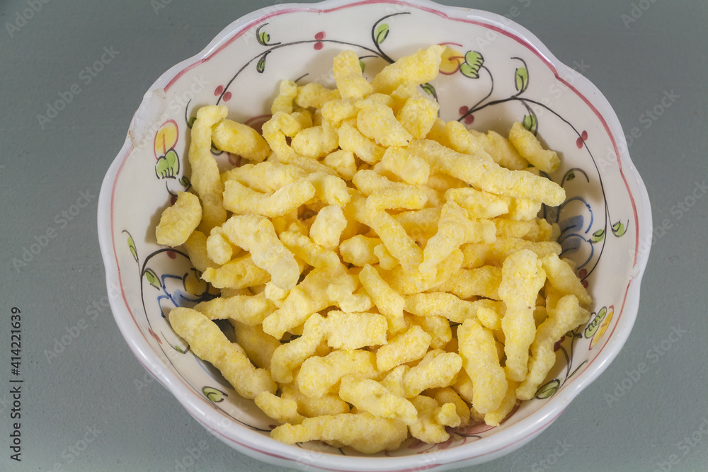 Puffed crackers in a bowl on gray background Puffed crackers in a bowl on gray background