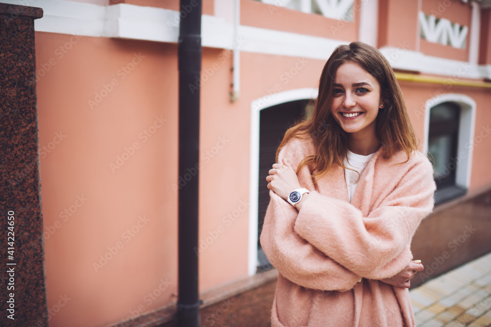 Woman with toothy smile folding hands