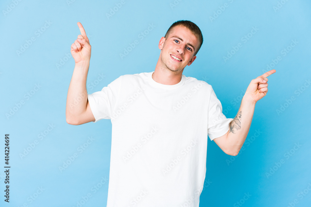 Young caucasian handsome man pointing to different copy spaces, choosing one of them, showing with finger. Young caucasian handsome man pointing to different copy spaces, choosing one of them, showing with finger.