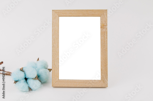 photo frame with cotton flower decor on white background