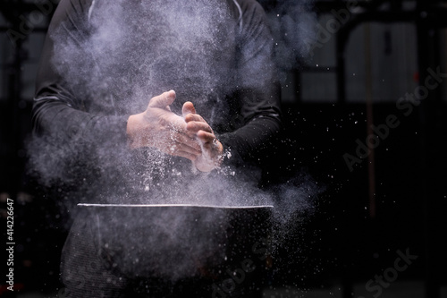 Bild auf Leinwand unrecognizable sportsman using talc powder before workout at gym, young male going to train with weights, bodybuilding and weightlifting concept