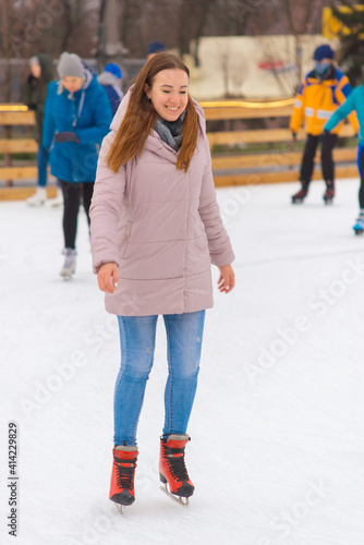 young beautiful woman ice skating in winter healthy lifestyle concept