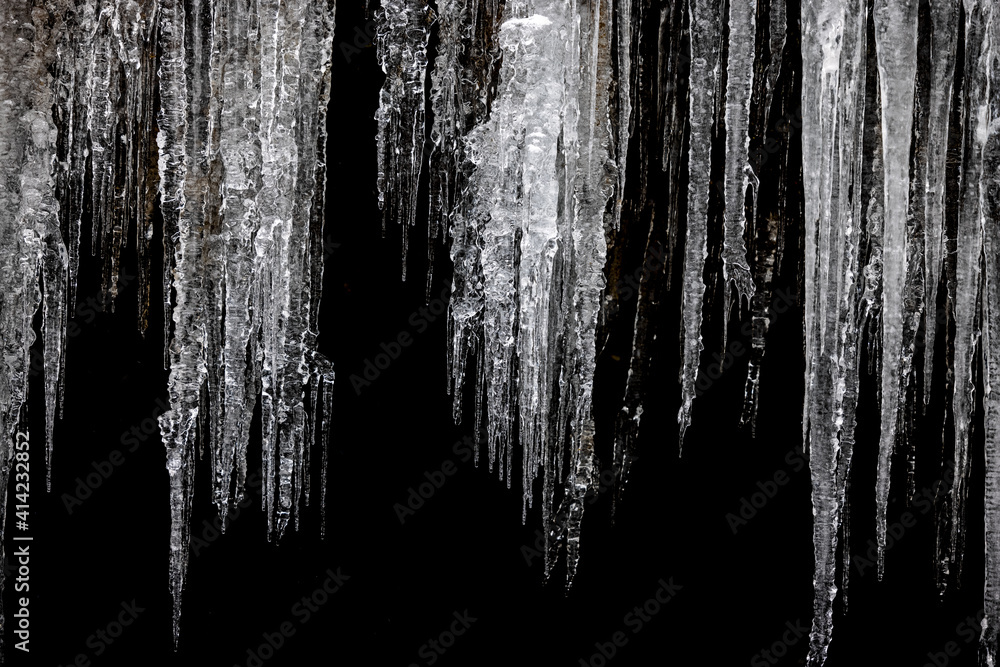 Frozen icicles on black background