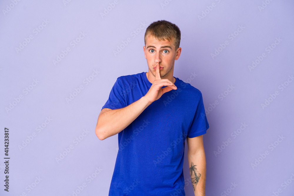 Young caucasian handsome man keeping a secret or asking for silence. Young caucasian handsome man keeping a secret or asking for silence.
