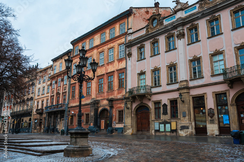 LVIV, UKRAINE: Rainy weather at town Market Square with lamposts and cobbled streets on. Lviv's Old Town is a part of UNESCO World Heritage List