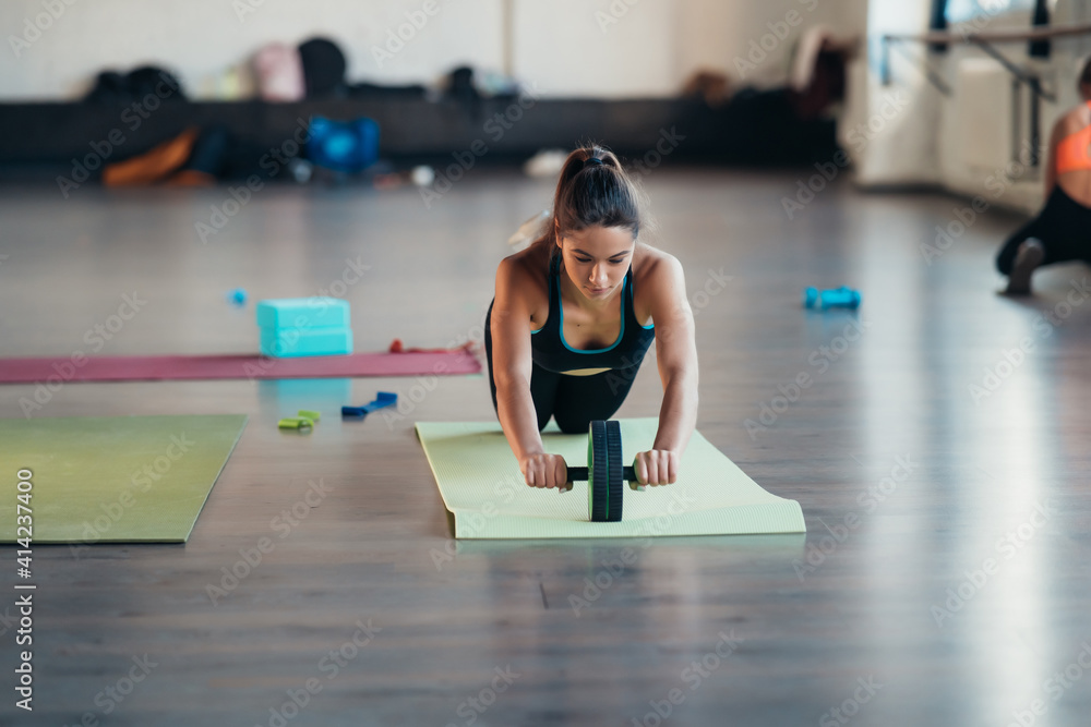Portrait of a young woman doing exercises at gym Portrait of a young woman doing exercises at gym