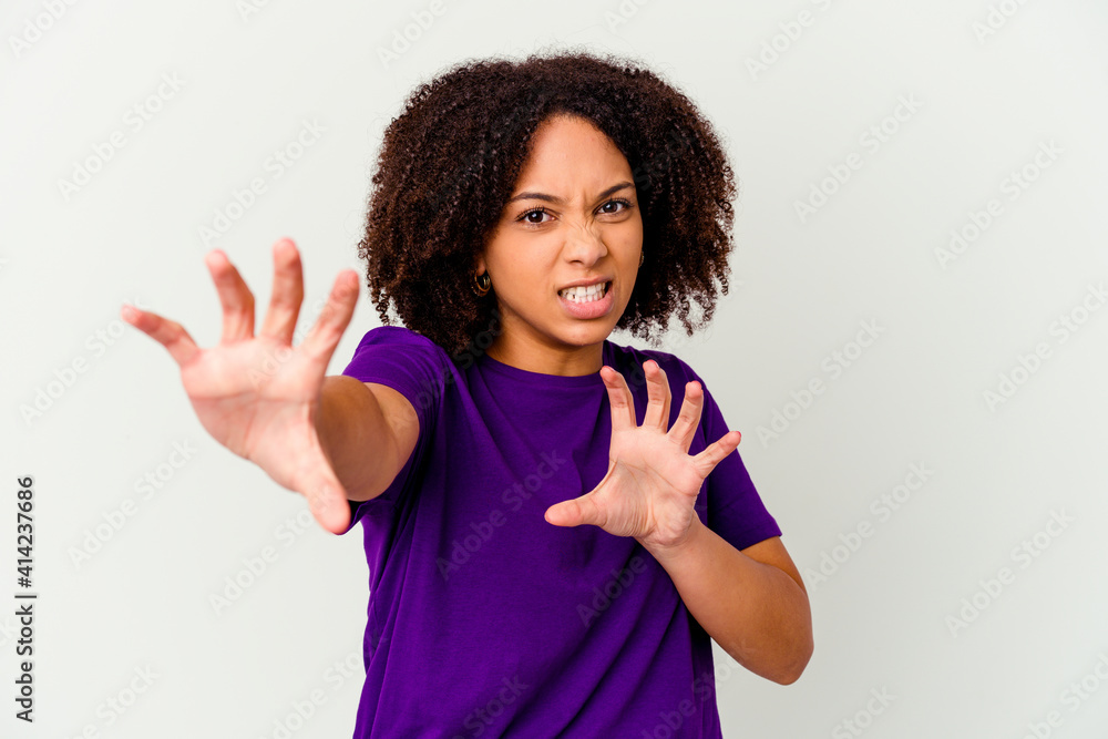 Young african american mixed race woman isolated showing claws imitating a cat, aggressive gesture. Young african american mixed race woman isolated showing claws imitating a cat, aggressive gesture.