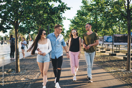 Happy multiethnic friends walking in park together