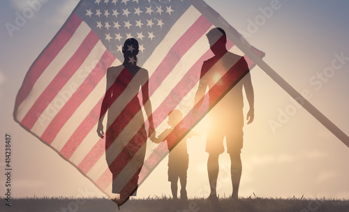 Patriotic family walking together on American flag background. American life concept. 