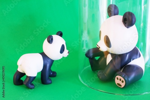 Canvastavla Little Panda toy outside the window glass, big Panda toy inside the window glass