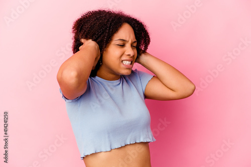 Young african american mixed race woman isolated covering ears with hands. © Asier