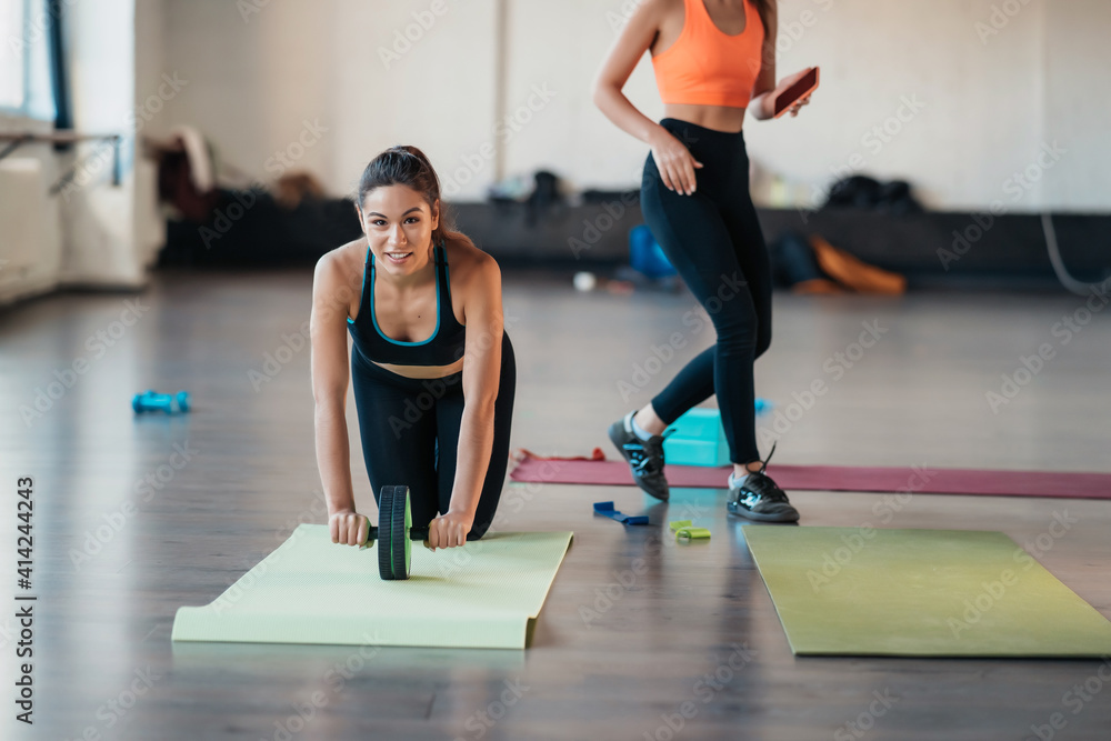 Portrait of a young woman doing exercises at gym Portrait of a young woman doing exercises at gym
