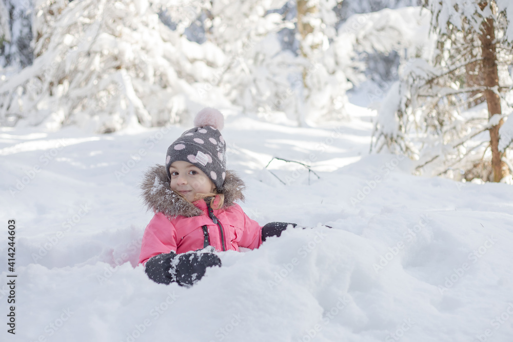 Little girl sitting in snow, have fun, enjoy wintertime. Little girl sitting in snow, have fun, enjoy wintertime.