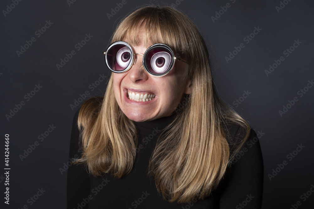 Blond female in funny glasses and a creepy smile Stock Photo Adobe Stock