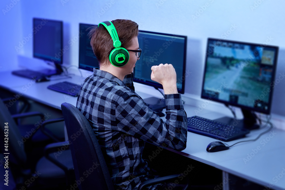 A professional gamer plays and wins a first-person game online on his personal computer. A professional gamer plays and wins a first-person game online on his personal computer.
