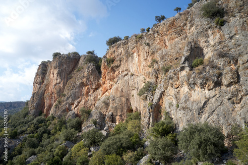 Rocky cliff with blue sky in the background. Valley with scenic rocky formation.
