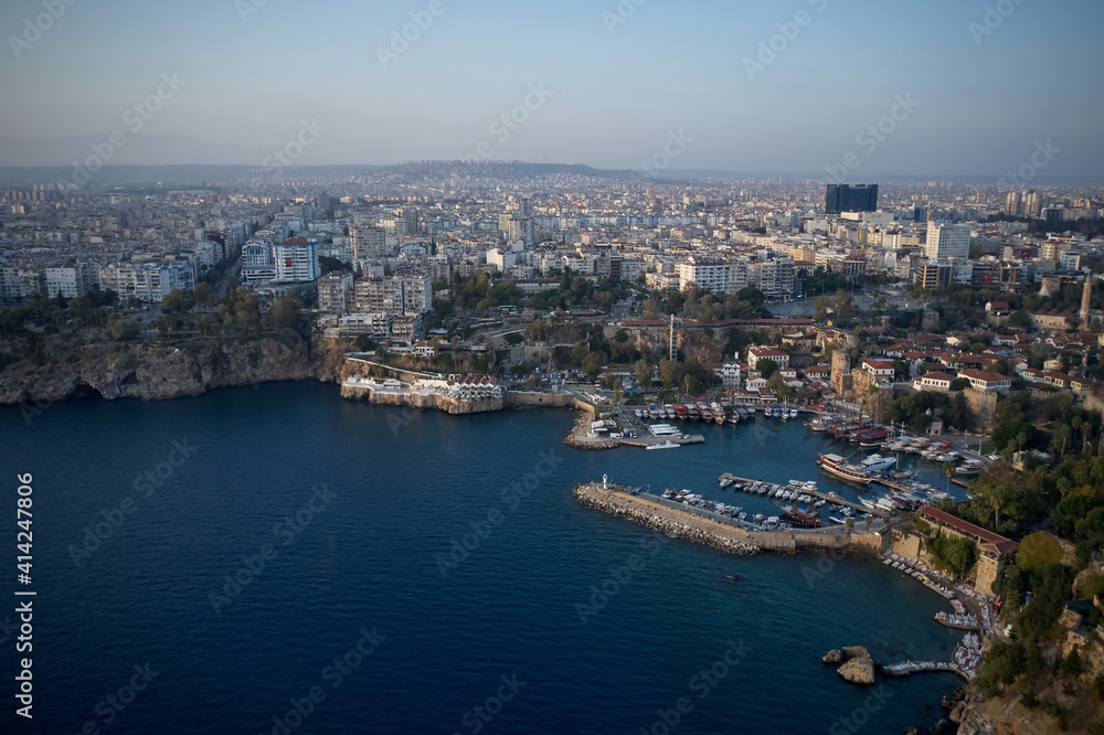 Beautiful Mediterranean seascape in Turkey. Panoramic view of sea coast with buildings on shore. Boats and yachts anchored at harbor in sea bay.
