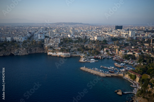 Beautiful Mediterranean seascape in Turkey. Panoramic view of sea coast with buildings on shore. Boats and yachts anchored at harbor in sea bay.