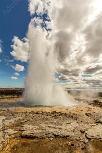Famous Haukadalur geyser erupting on a sunny day