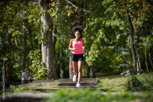 young metis woman running in a park