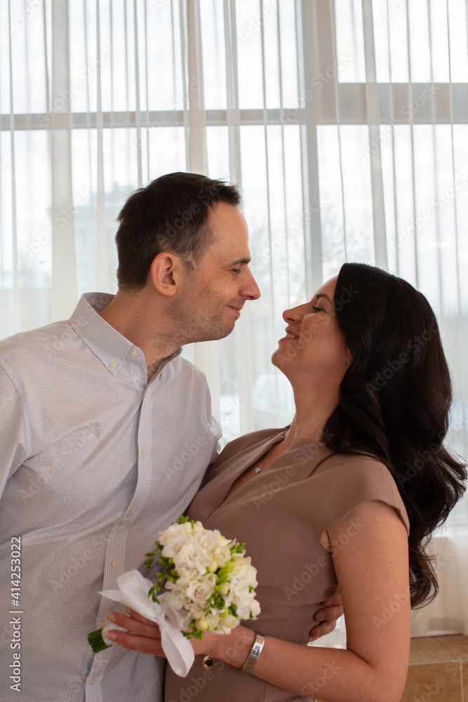 Beautiful and happy newlyweds marry each other and get married. New family and marriage. Registration at the registry office Beautiful and happy newlyweds marry each other and get married. New family and marriage. Registration at the registry office