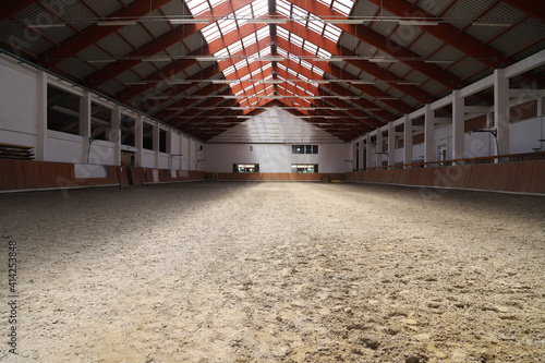 Photo of an empty indoor riding hall for horses and riders