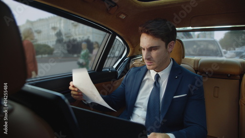 Stressed business man getting angry with poor results in business car. © stockbusters