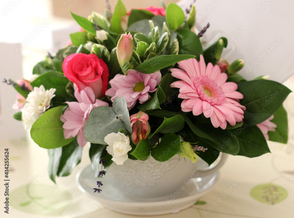 Bouquet of pink flowers in a large cup
Bouquet of pink flowers in a large cup