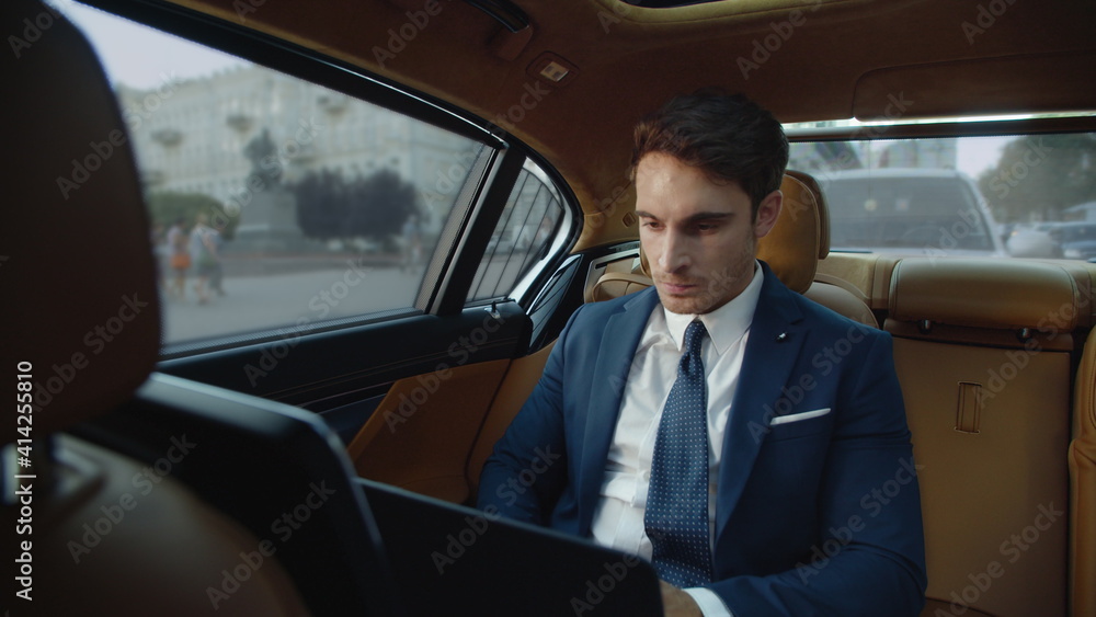 Aggressive businessman getting angry near laptop computer screen in modern car. Aggressive businessman getting angry near laptop computer screen in modern car.