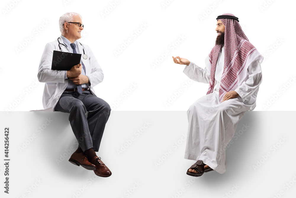 Mature male doctor and a saudi arab man sitting on a blank panel and talking