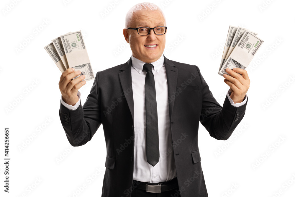 Mature businessman holding stacks of us dollar banknotes Mature businessman holding stacks of us dollar banknotes