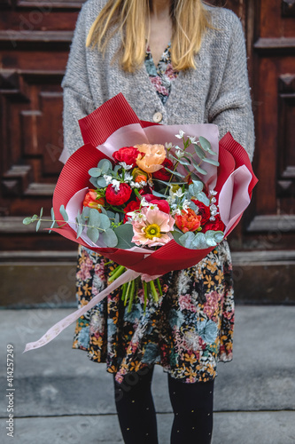 Spring. Woman holds a beautiful bouquet of flowers in her hands © Yevhen