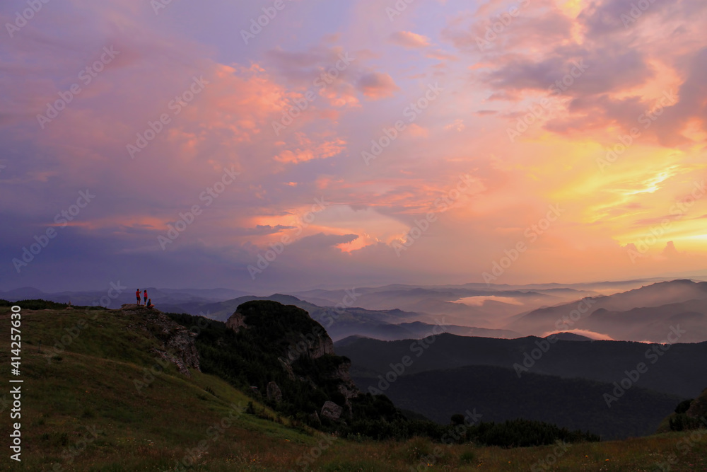 tourists watching the sunrise in the Carpathian mountains