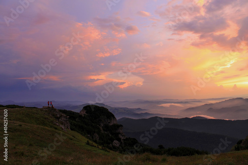 tourists watching the sunrise in the Carpathian mountains