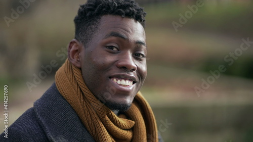 Young handsome black African man portrait looking at camera wearing winter clothing