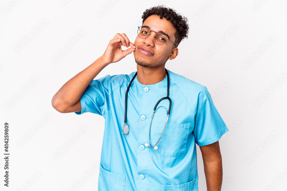 Young african american curly nurse man isolated with fingers on lips keeping a secret. Young african american curly nurse man isolated with fingers on lips keeping a secret.