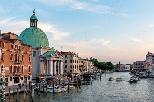 Venice's canal, boat and traditional Venetian houses view. 