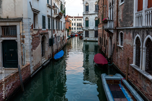 Venice s canal  boat and traditional Venetian houses view. 