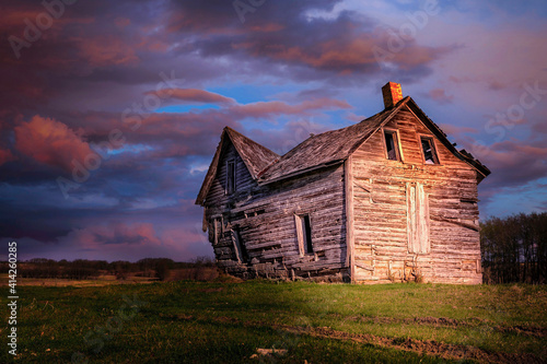 evening sun shining on an old derelict house.