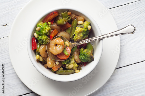 Bowl of warm shrimp, broccoli and paprika salad