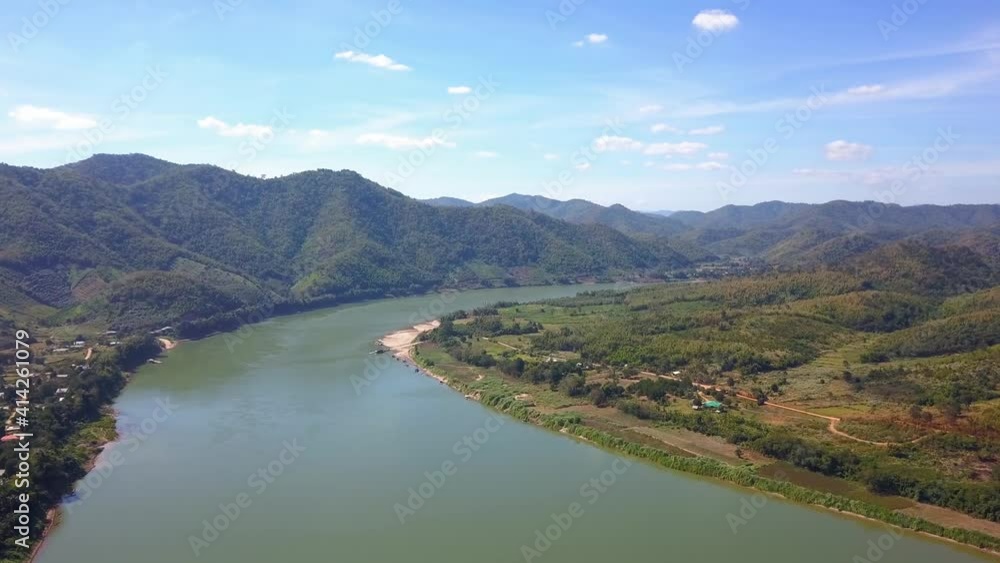Pristine View Of Famous Mekong River Surrounded By Lush Green Valleys And Mountains Under Summer Blue Sky - Aerial Drone Wide Shot Pristine View Of Famous Mekong River Surrounded By Lush Green Valleys And Mountains Under Summer Blue Sky - Aerial Drone Wide Shot