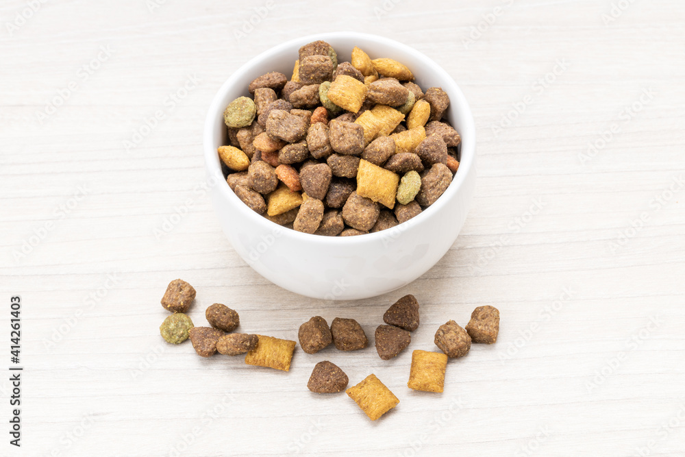 domestic pet dry food on wooden background. dried cat feed. above view domestic pet dry food on wooden background. dried cat feed. above view