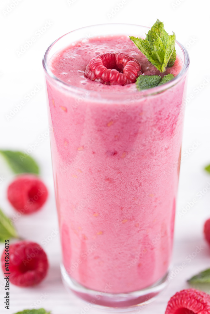 Raspberry smoothie with fruit and mint garnish on white background Raspberry smoothie with fruit and mint garnish on white background