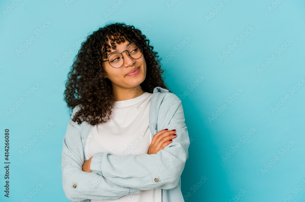 Young african american afro woman isolated dreaming of achieving goals and purposes Young african american afro woman isolated dreaming of achieving goals and purposes