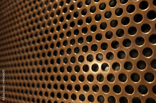 bronze shiny metal grille
 as an abstract background
 photo