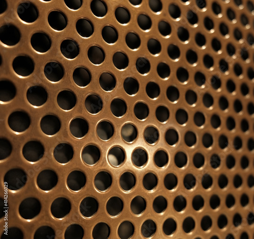 bronze shiny metal grille
 as an abstract background
 photo