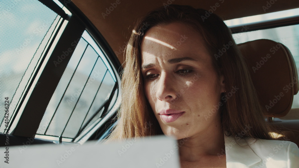 Surprised business woman feeling success with project results in business car. Surprised business woman feeling success with project results in business car.
