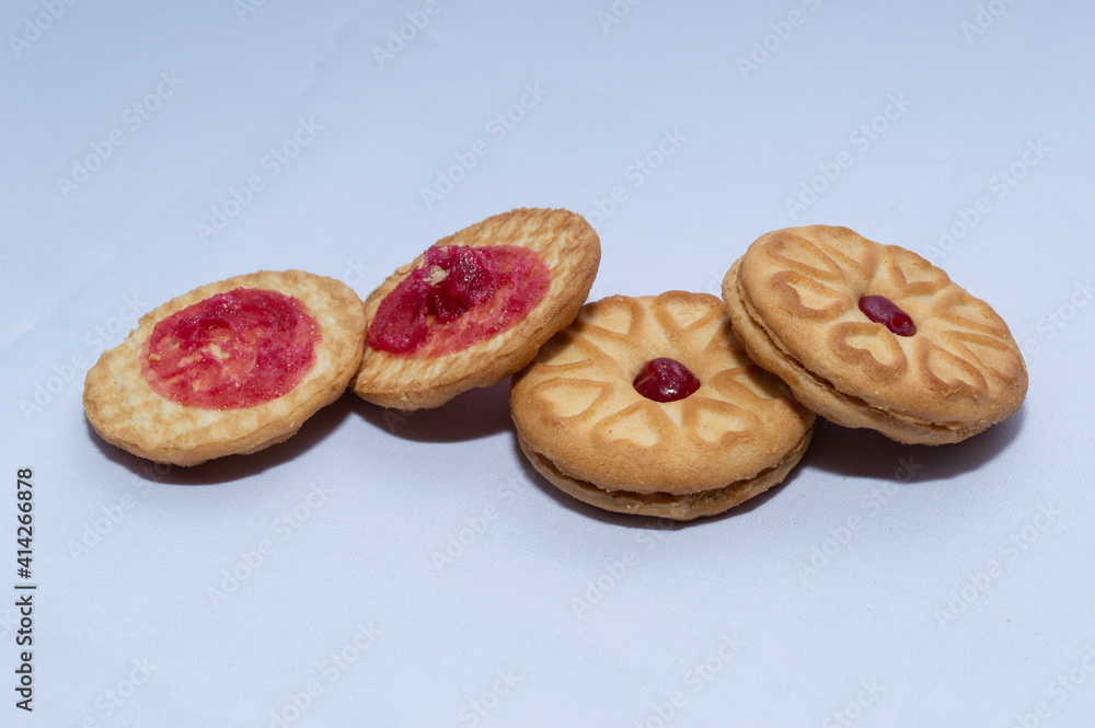 Red centered jam biscuits with a strawberry flavor and on a plain white background Red centered jam biscuits with a strawberry flavor and on a plain white background