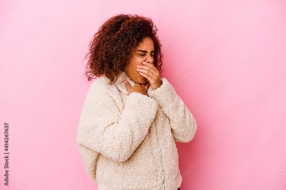 Young african american woman isolated on pink background suffers pain in throat due a virus or infection. Young african american woman isolated on pink background suffers pain in throat due a virus or infection.