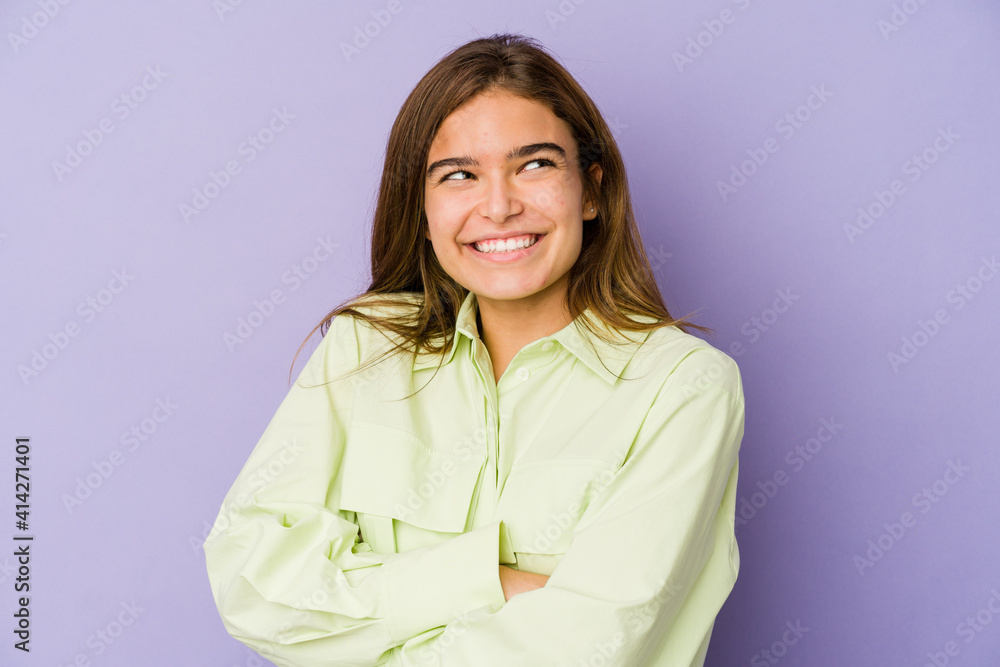 Young skinny caucasian girl teenager on purple background smiling confident with crossed arms. Young skinny caucasian girl teenager on purple background smiling confident with crossed arms.